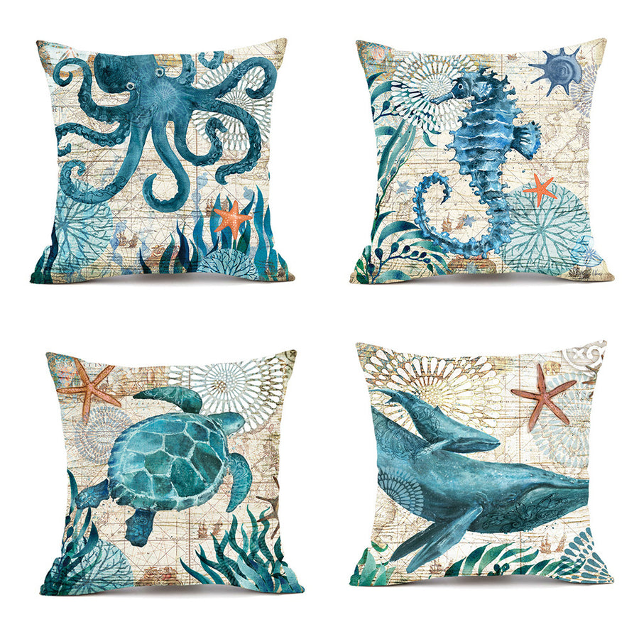 Set of four decorative pillows with ocean-themed designs on a white background.