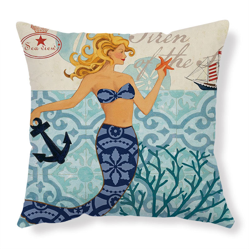 Decorative pillow with mermaid design holding a starfish and anchor on a blue and white patterned background.