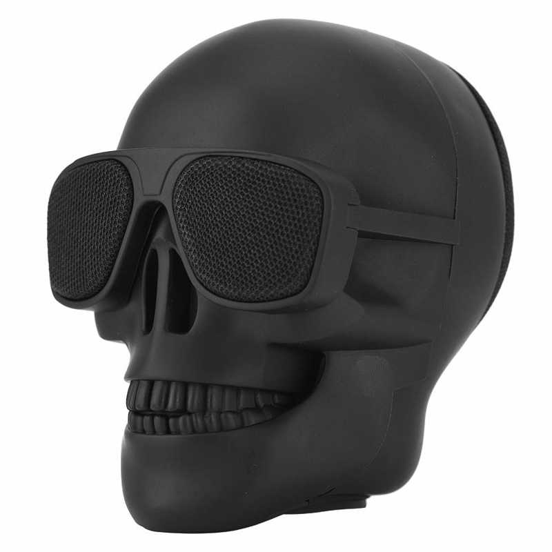 Black skull-shaped speaker with sunglasses on a white background