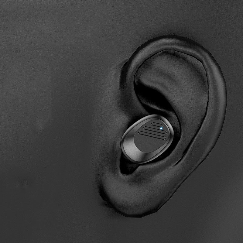 Black wireless earbud in an ear on a dark background
