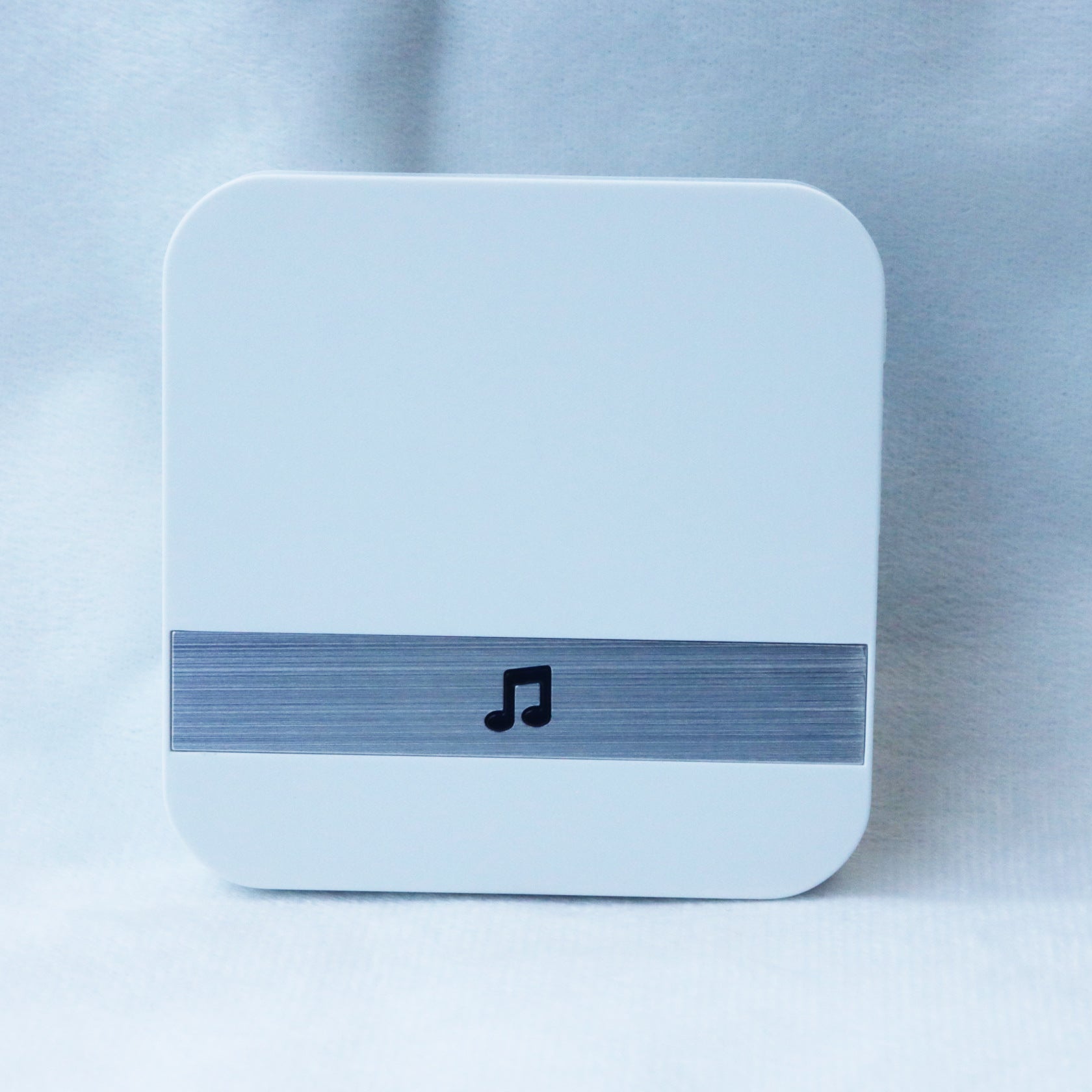 Square white device with a blue stripe and music note icon on a light gray background