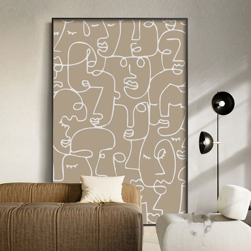 Abstract line art of faces on a wall in a modern living room.