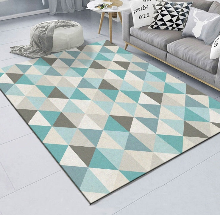 Geometric patterned rug in a living room with a sofa and coffee table.
