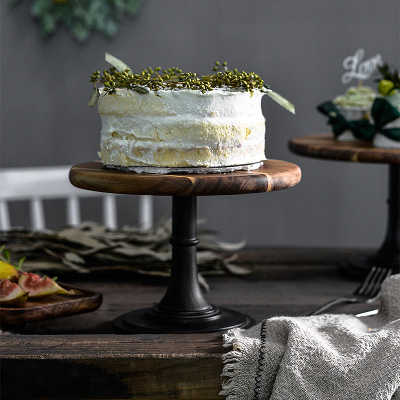Decorative cake on a wooden stand with a neutral background