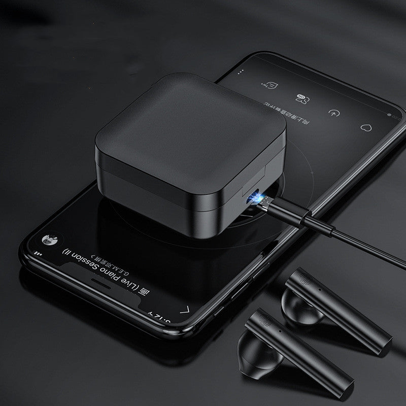 Black wireless earbuds charging case with earbuds on a dark surface