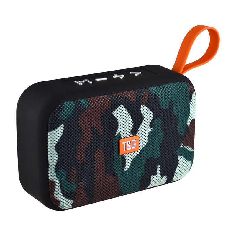 Camouflage-patterned portable speaker with orange handle and visible brand logo on a white background