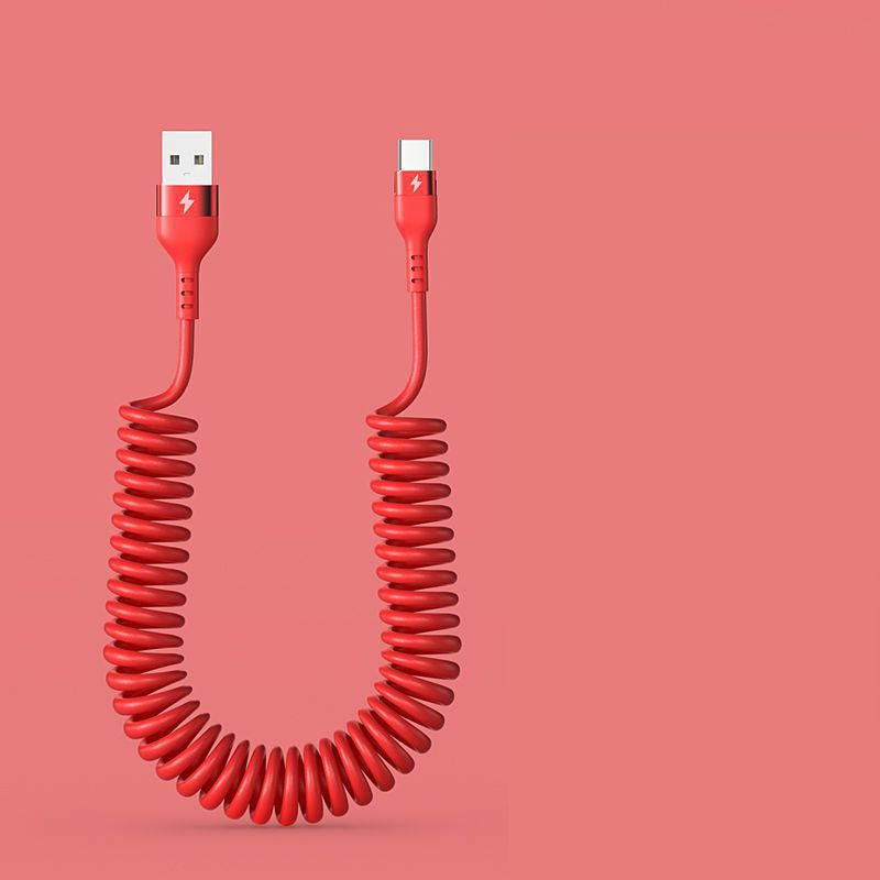 Red coiled USB cable on a pink background