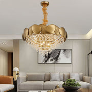 Luxurious gold chandelier in a living room setting with a sofa and decor.
