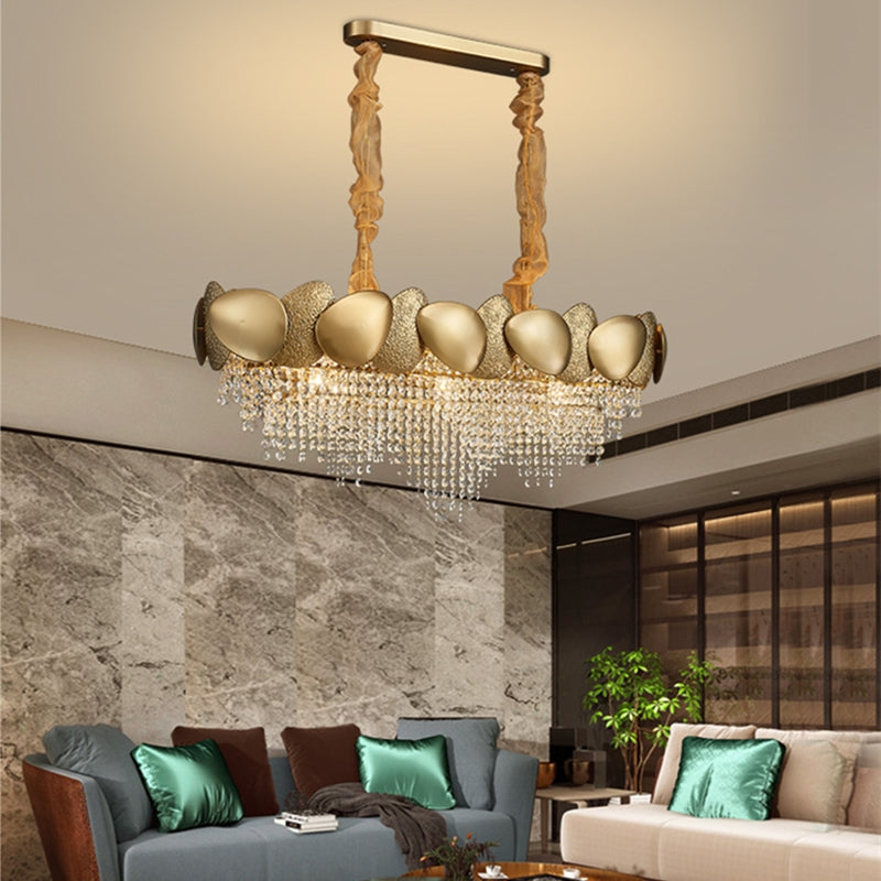 Luxurious chandelier hanging in a modern living room with gray walls and furniture.