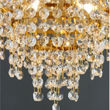 Close-up of a crystal chandelier with gold accents on a dark background