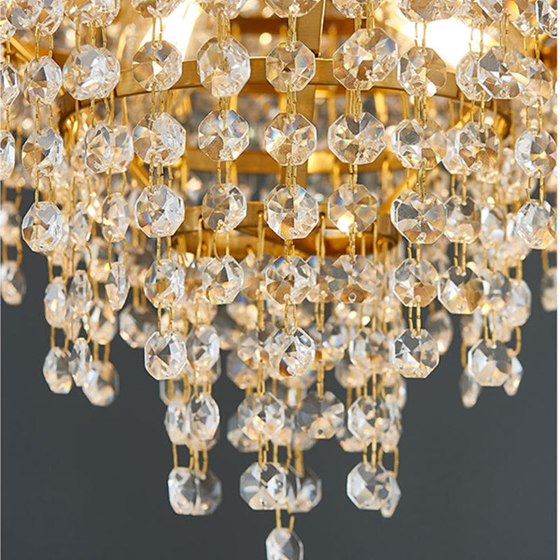 Close-up of a crystal chandelier with gold accents on a dark background