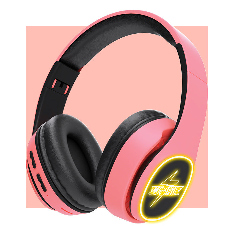Pink and black headphones with a neon logo on a pink background