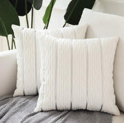 White textured throw pillows on a sofa with a neutral background