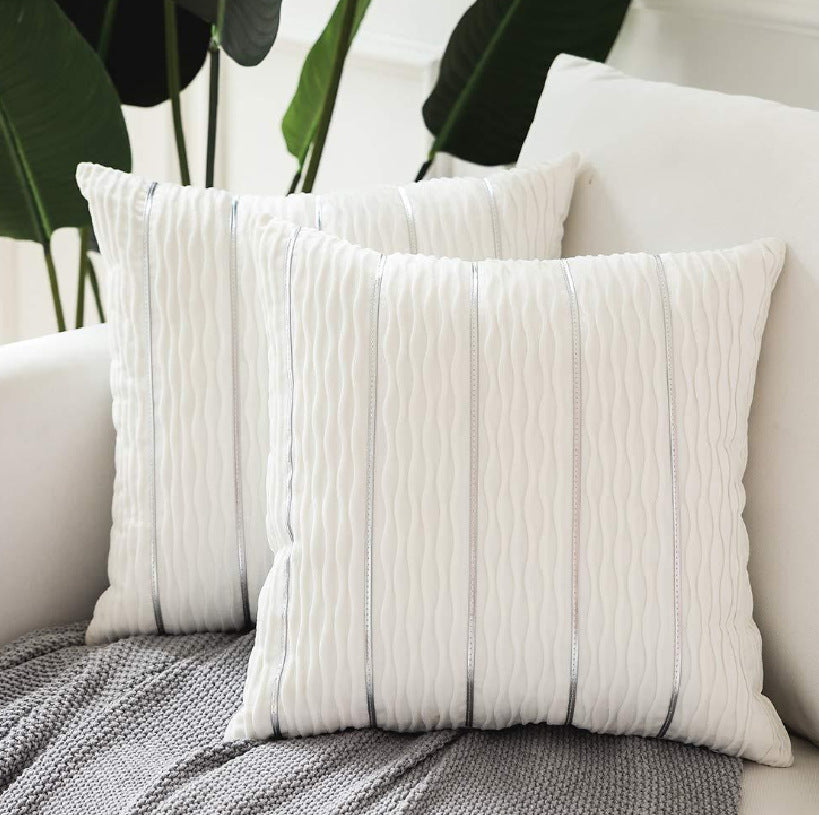 White textured throw pillows on a sofa with a neutral background