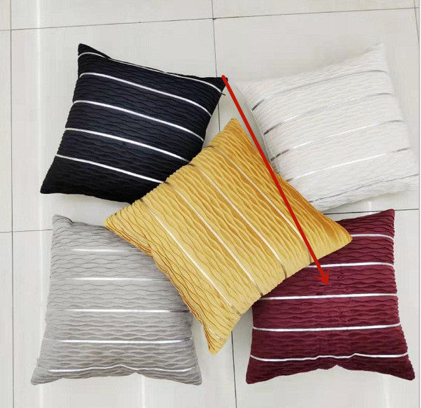 Five striped pillows in black, yellow, gray, red, and white on a light gray background.