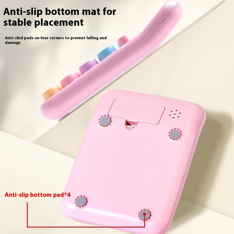 Pink electronic device with anti-slip bottom mat on a light beige background