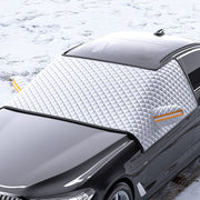 Car with a white quilted cover on a snowy background