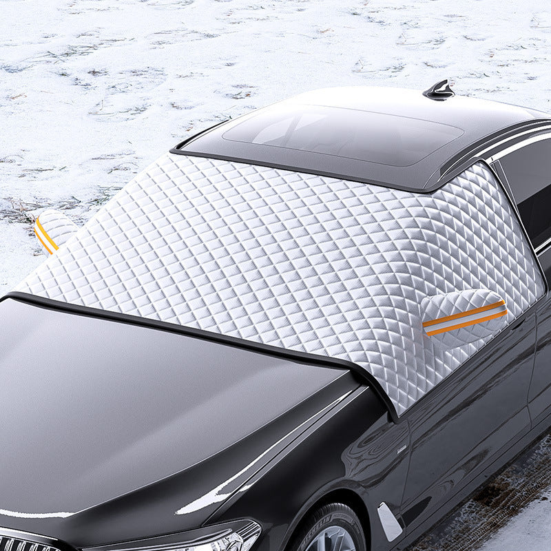 Car with a white quilted cover on a snowy background