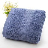 Rolled blue towel with textured pattern on a white background