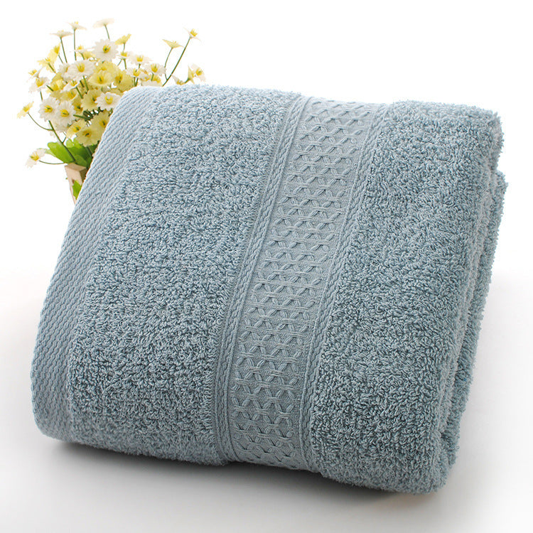 Folded light blue towel with a textured pattern on a white background