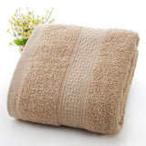 Beige textured towel with a decorative border on a white background