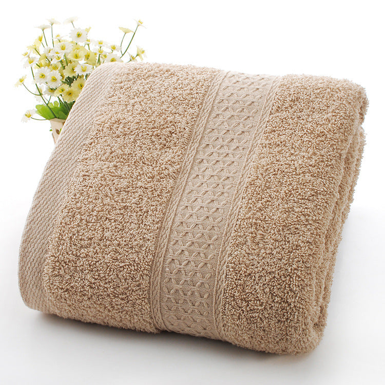 Beige textured towel with a decorative border on a white background