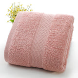 Pink towel with textured pattern on a white background
