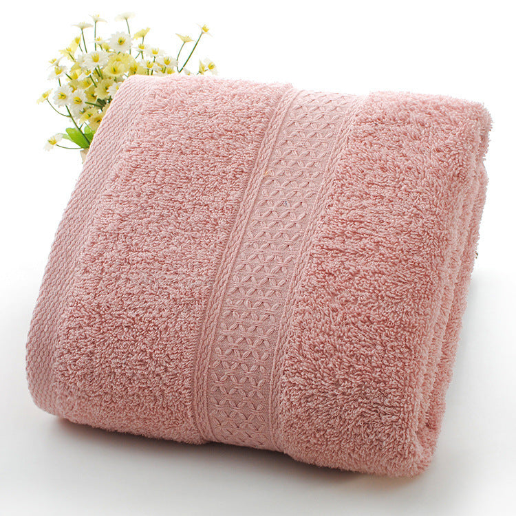 Pink towel with textured pattern on a white background