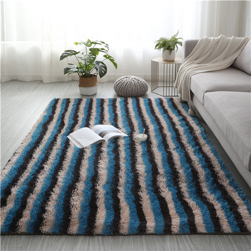 Striped area rug with books and a plant in a living room setting