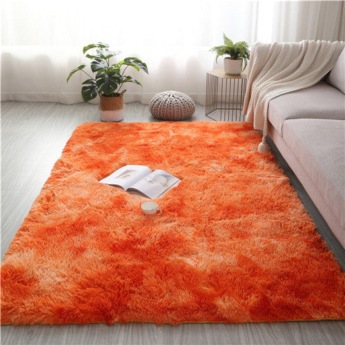 Orange rug in a living room with a couch, plants, and a magazine.