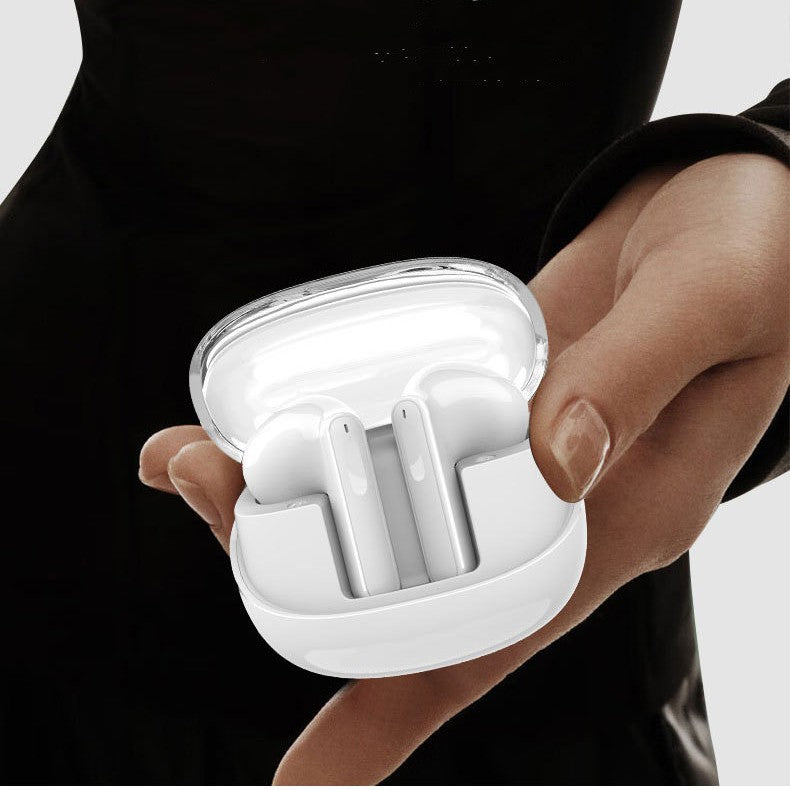 White wireless earbuds in a charging case held by a person against a neutral background