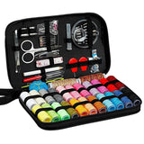 Sewing kit with various tools and colorful thread spools in a black case.