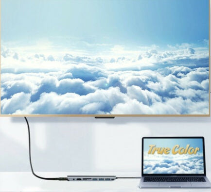 Laptop displaying 'True Color' with a scenic view of clouds on the screen