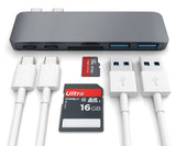 USB hub with multiple ports, cables, and a 16GB memory card on a white background