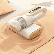 Handheld vacuum cleaner on a bed with text indicating features