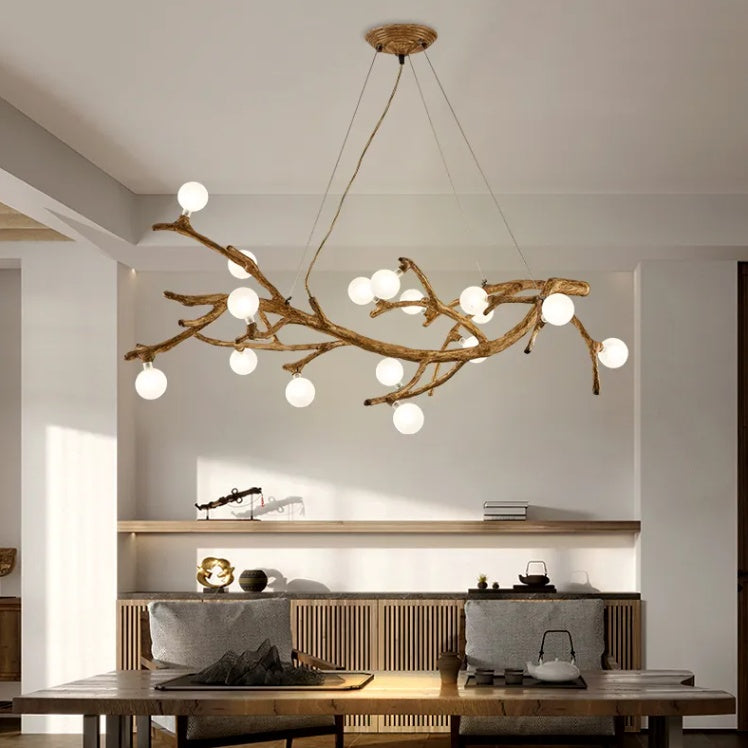 Modern chandelier with branch-like design in a dining room setting