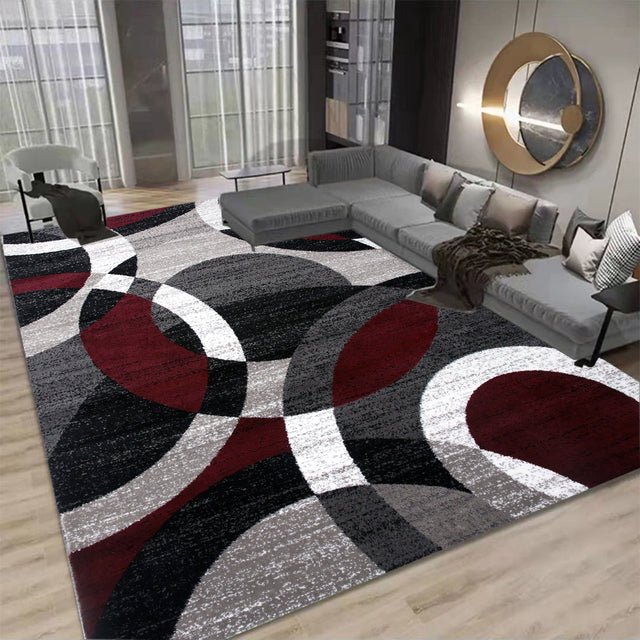 Living room with a geometric patterned rug featuring red, black, and gray circles.