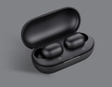 Black wireless earbuds in an open case on a gray background
