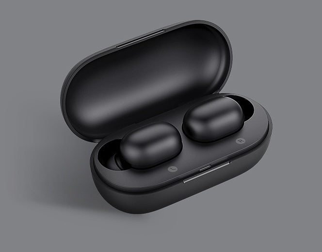 Black wireless earbuds in an open case on a gray background