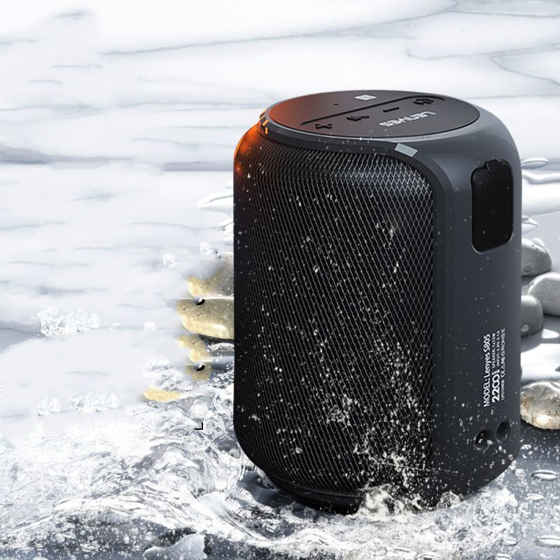 Black portable speaker with water resistance feature in a wet environment