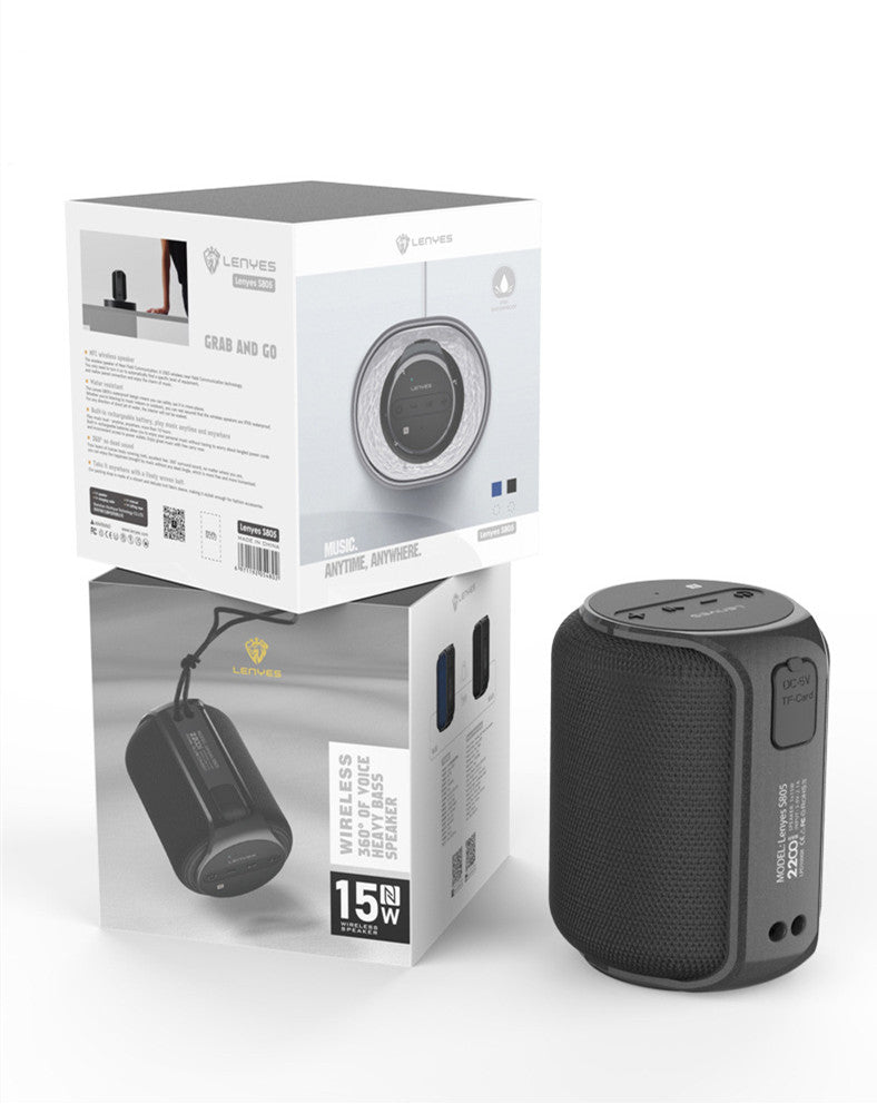 Black portable speaker with its packaging on a white background