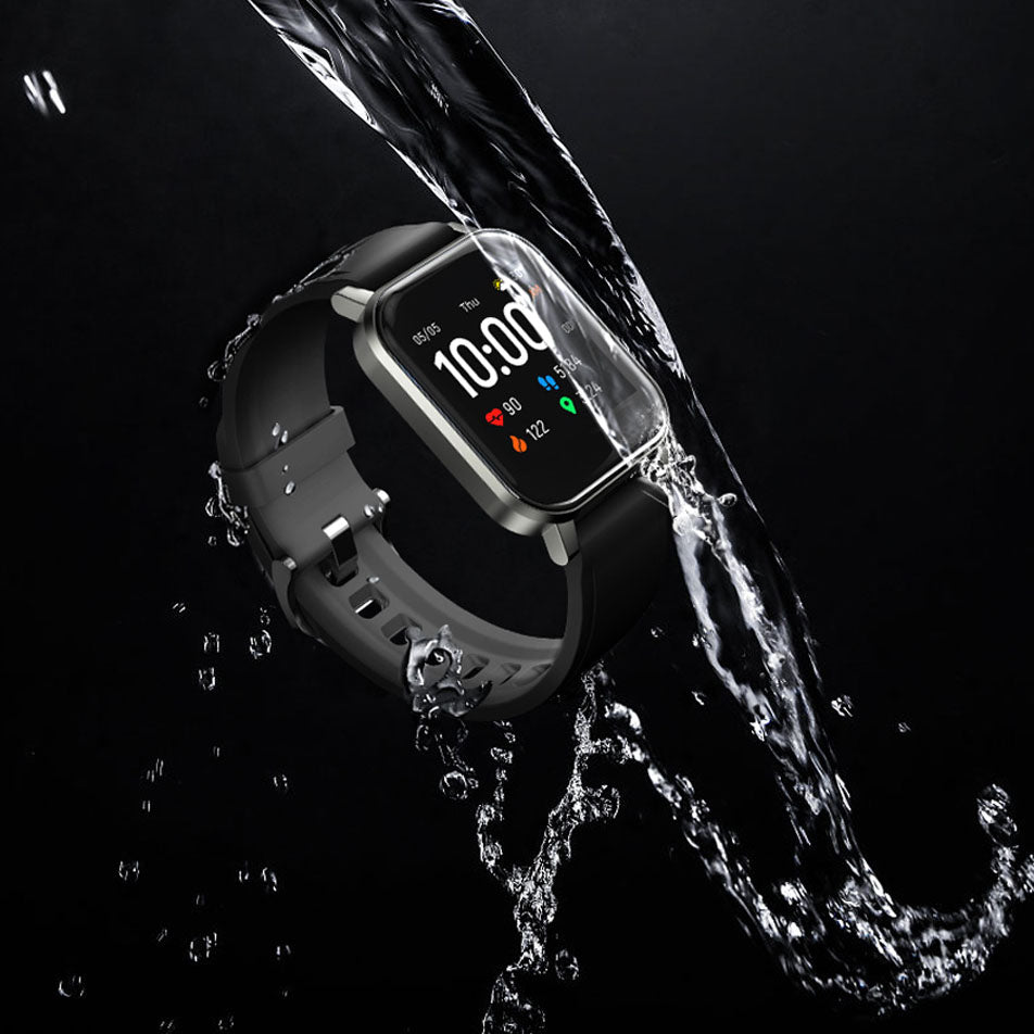 Smartwatch with water splashing around it on a black background