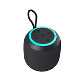 Black portable speaker with a blue light on a white background