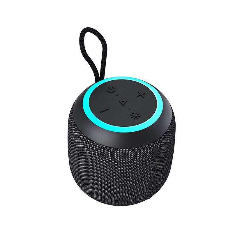 Black portable speaker with a blue light on a white background