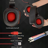 Black and red gaming headset with ear cushions, microphone, audio, and USB cable on a dark background.