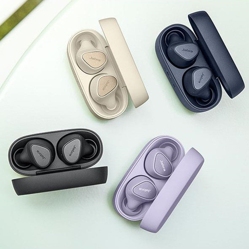Set of wireless earbuds in various colors with their charging cases on a light green background.