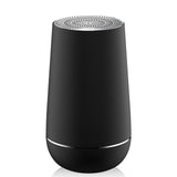 Black cylindrical device with a patterned top on a white background