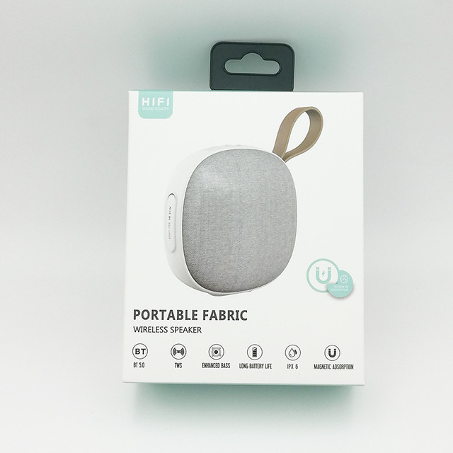 Portable fabric wireless speaker packaging on a light gray background