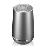 Silver cylindrical speaker on a white background