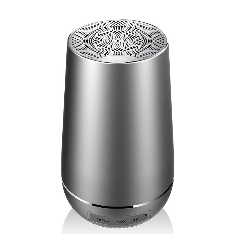 Silver cylindrical speaker on a white background